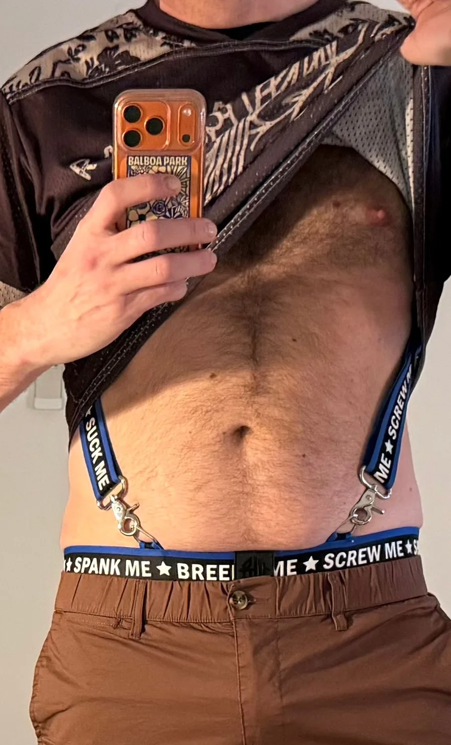 The full mirror selfie: torso, blue suspenders and a printed waistband