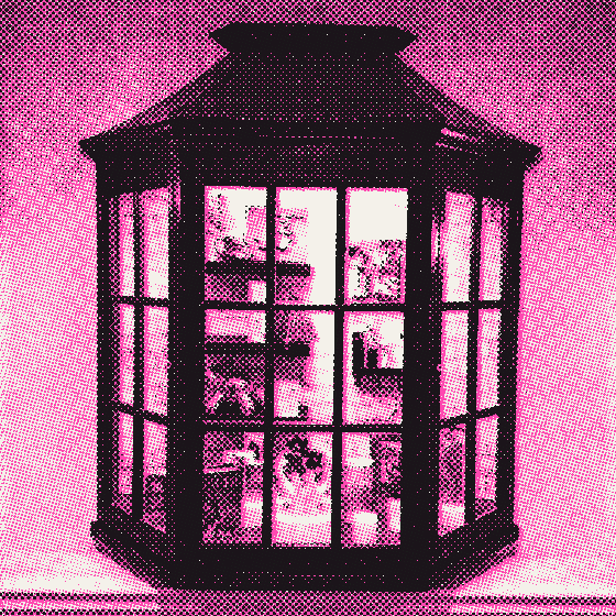 A lit wooden display cabinet full of small objects and a neon sign