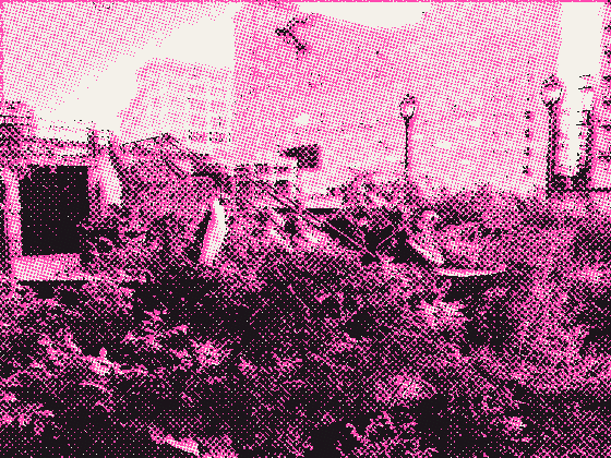 A riverwalk garden with painted sculptures below brick towers
