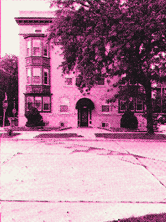 A pale brick apartment building with green bay windows and 1503 over the door