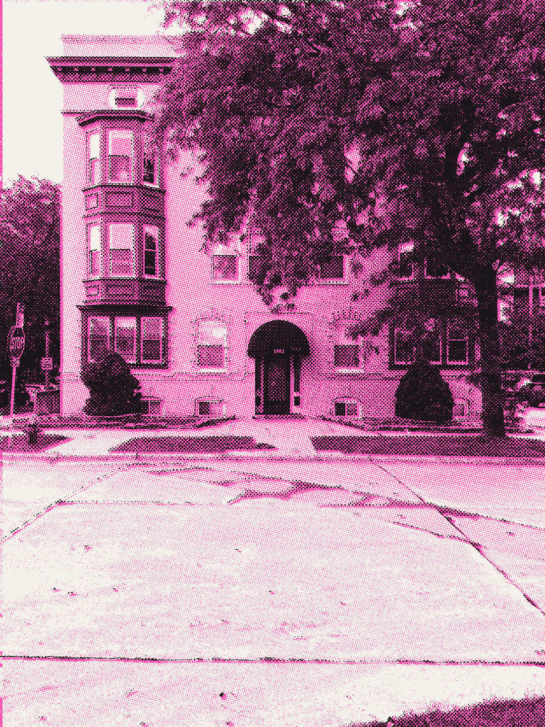 A pale brick apartment building with green bay windows and 1503 over the door