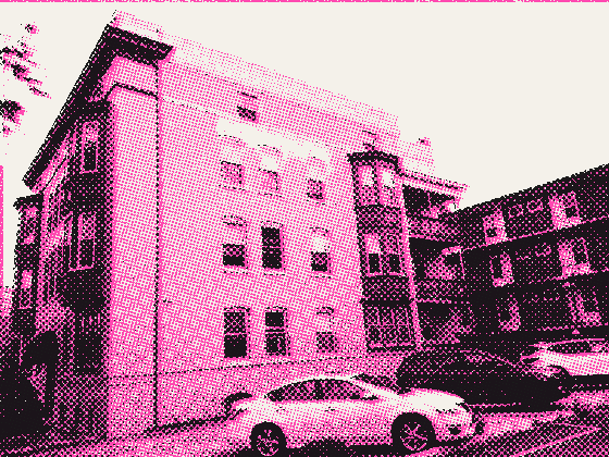 The same building from the side, cars parked along it