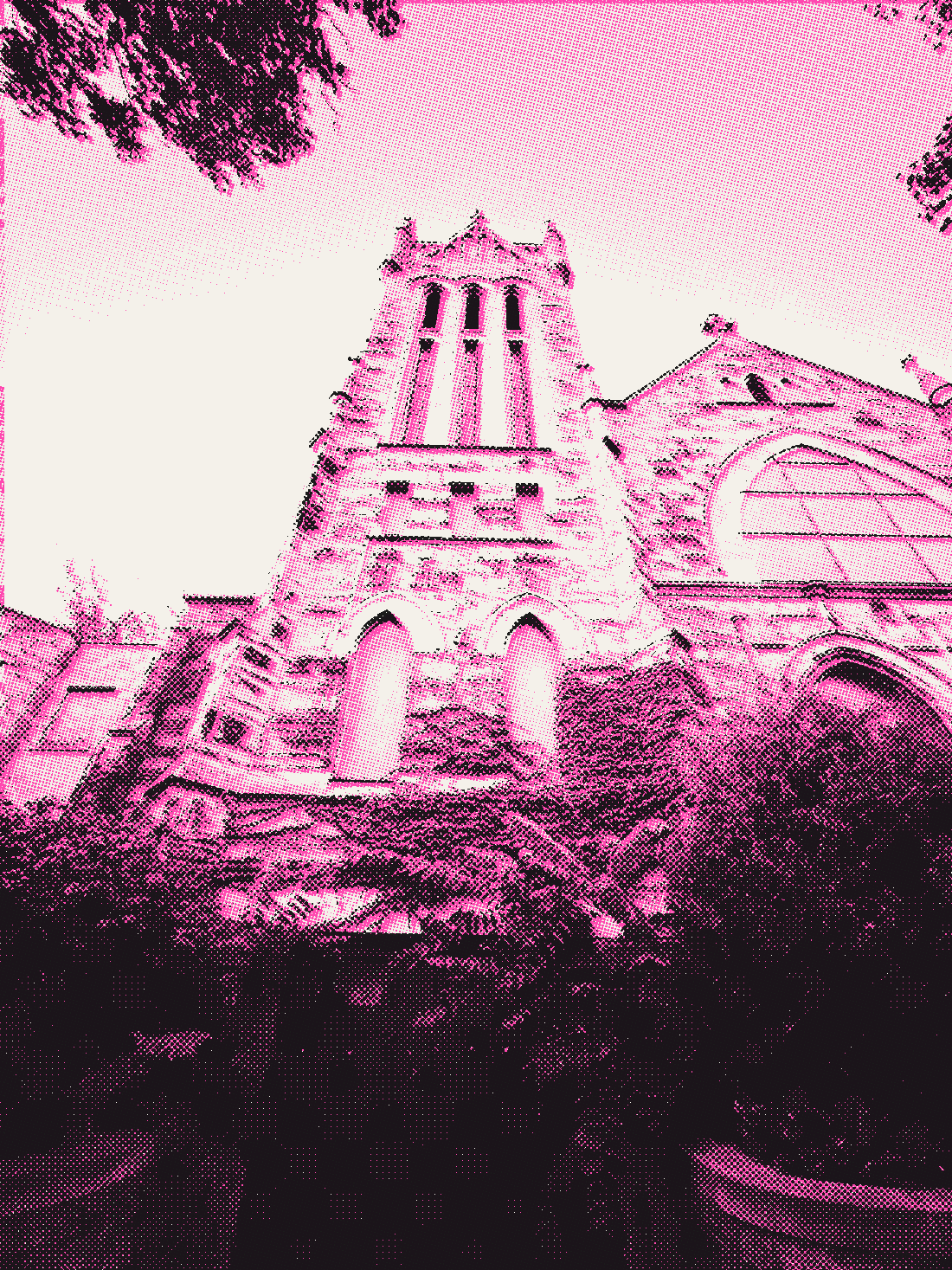 A stone church tower seen from below through trees