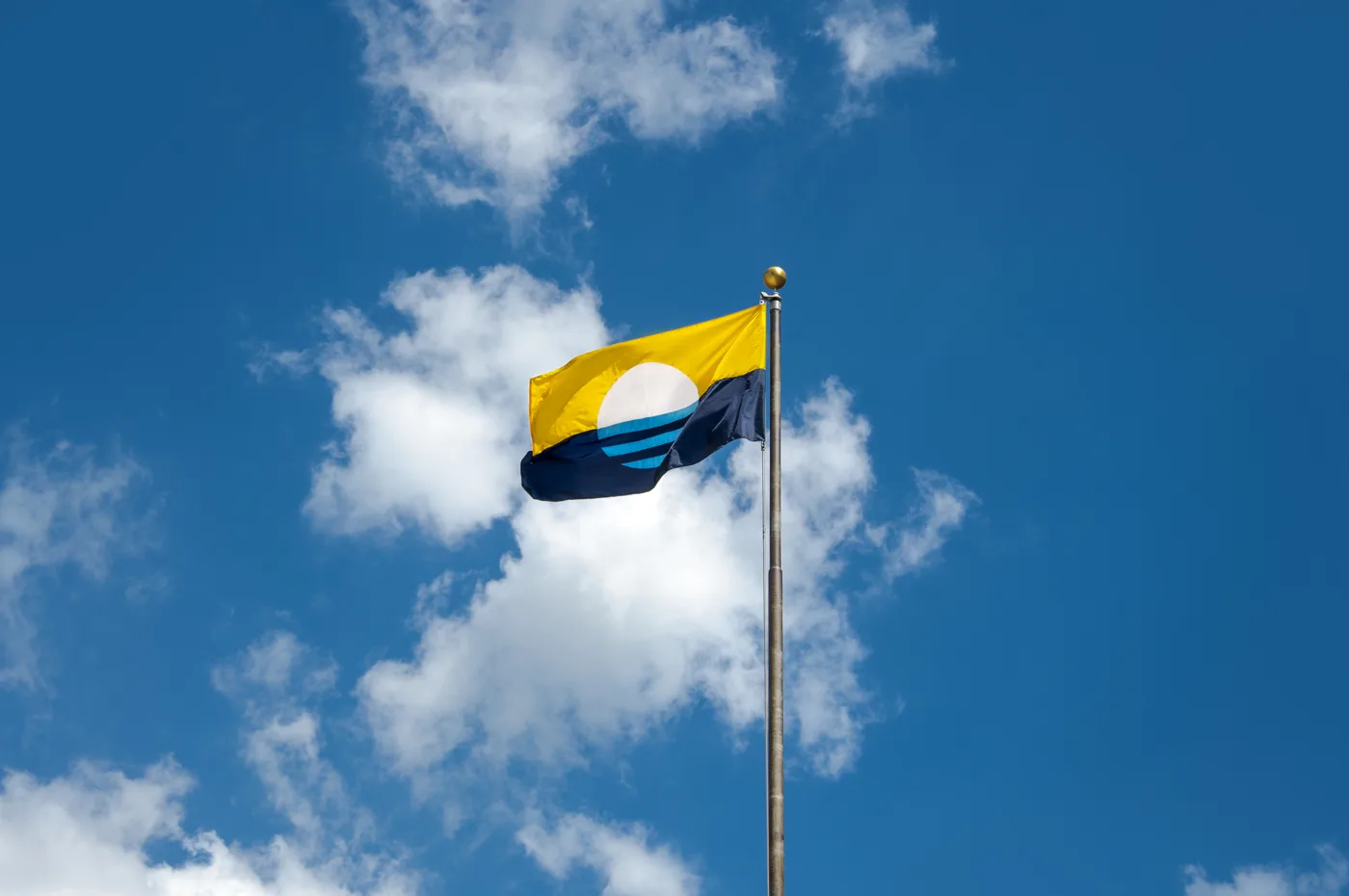 The People's Flag of Milwaukee flying against a blue sky