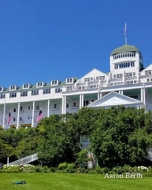 A white Victorian grand hotel with a long front porch on Mackinac Island
