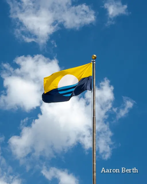 The Milwaukee flag flying against a blue sky with white clouds