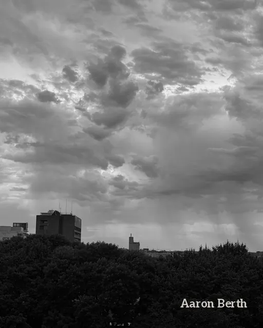 Black and white: storm clouds and a curtain of rain over the city skyline
