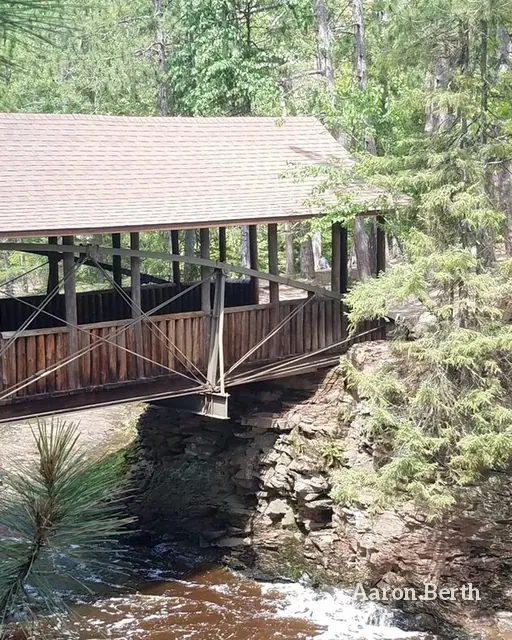 The covered bridge over Amnicon Falls in the woods