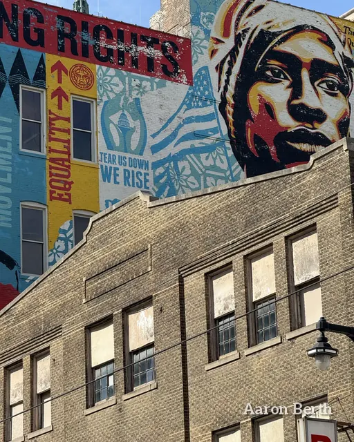 A large mural of a face on the side of a Milwaukee building