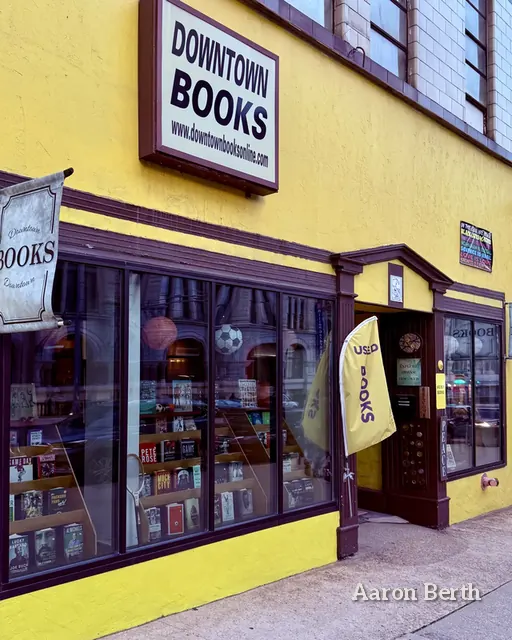 A bright yellow Milwaukee bookstore storefront with books in the windows