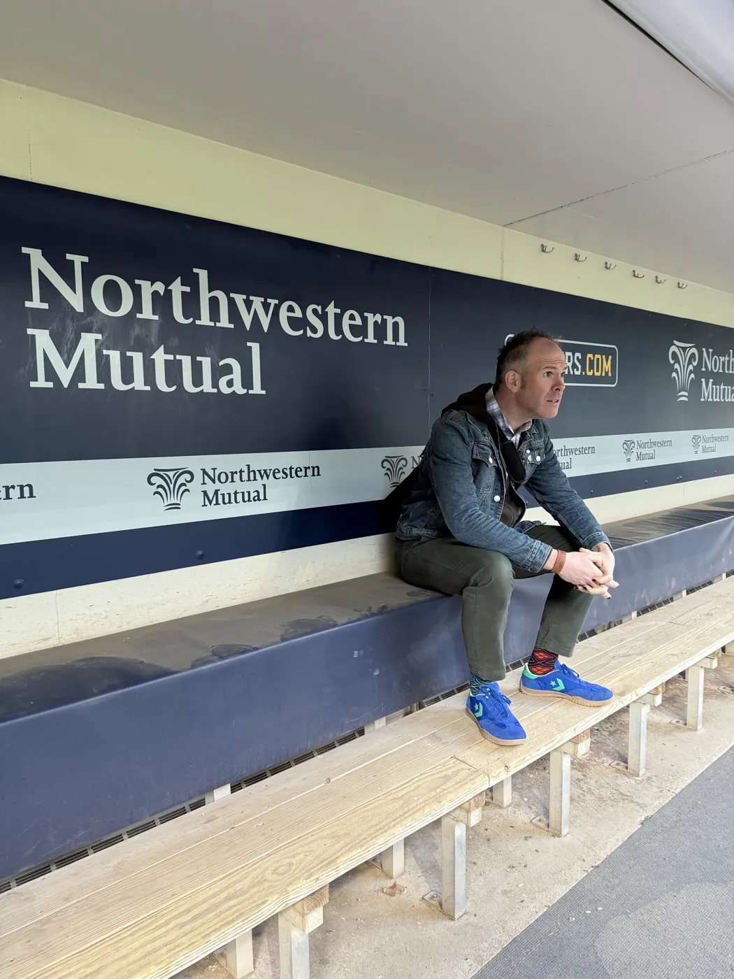 Aaron Berth sitting on the home dugout bench