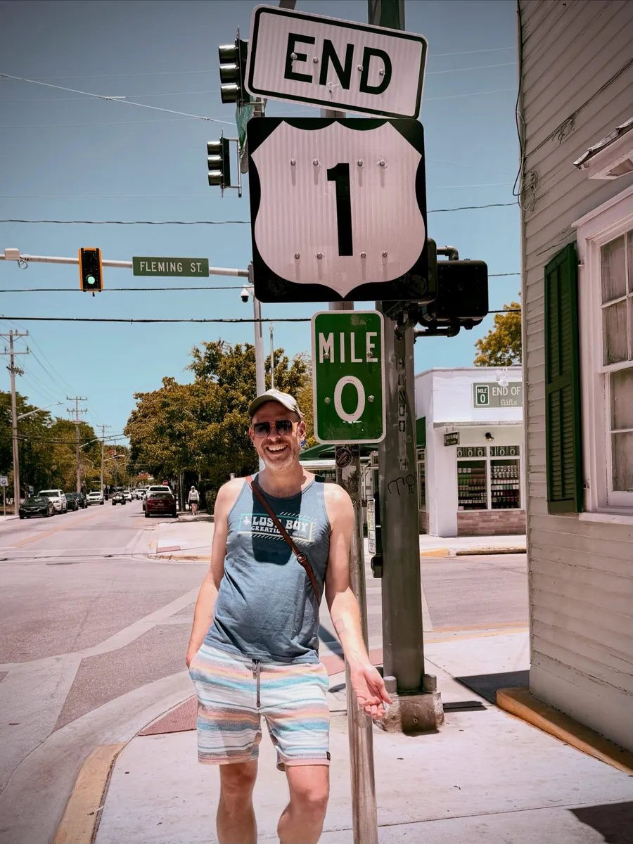 Aaron under the End 1 and Mile 0 highway signs in Key West