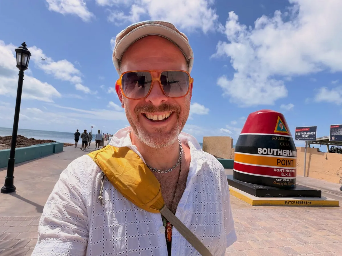 Aaron in sunglasses at the Southernmost Point buoy