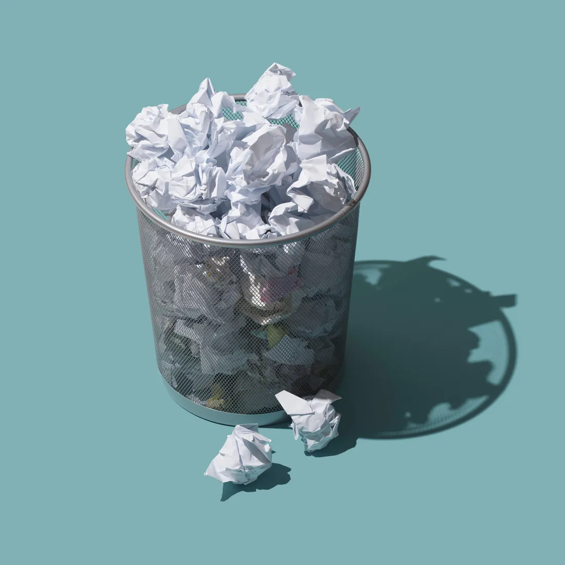 A wastebasket full of crumpled paper